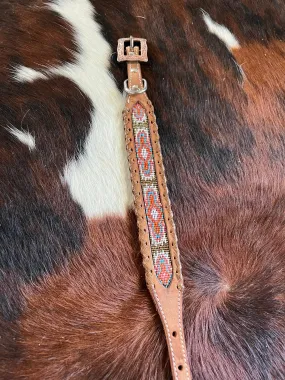 Genuine leather dog collar with pink, white, and gold navajo beaded inlay design, a leather wrapped edge